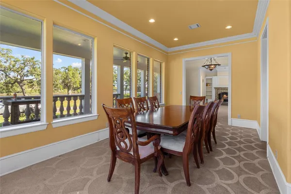 a view of a dining room with furniture large windows and wooden floor