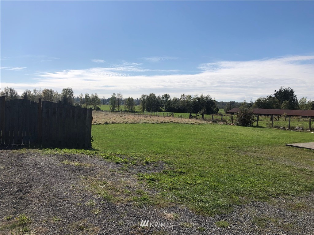 739 Lange Road Bellingham, WA 98226 - Photo 6 of 23 a view of a garden with a building in the background