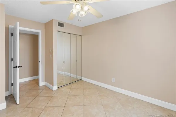 a bathroom with a granite countertop sink toilet mirror and shower