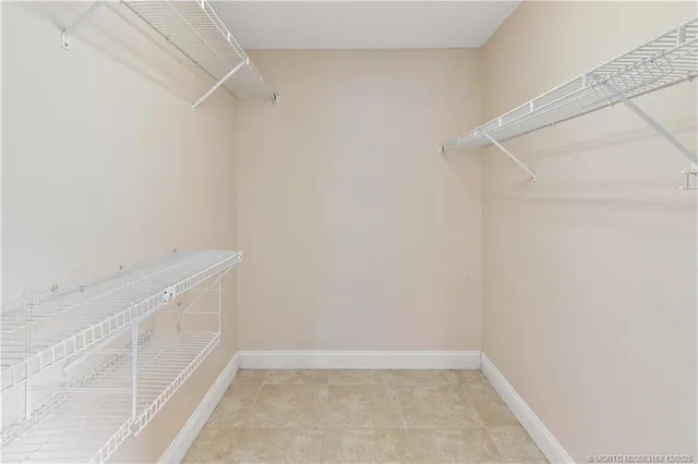 a bathroom with a glass door shower a sink and a toilet