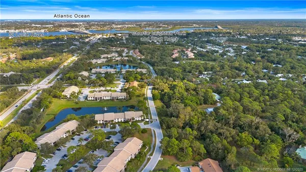 an aerial view of a residential houses with outdoor space and street view
