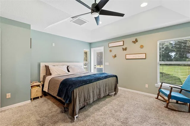 a bathroom with a granite countertop sink a toilet and a shower curtain