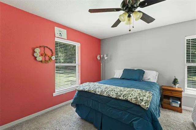 a living room with furniture a chandelier and a flat screen tv