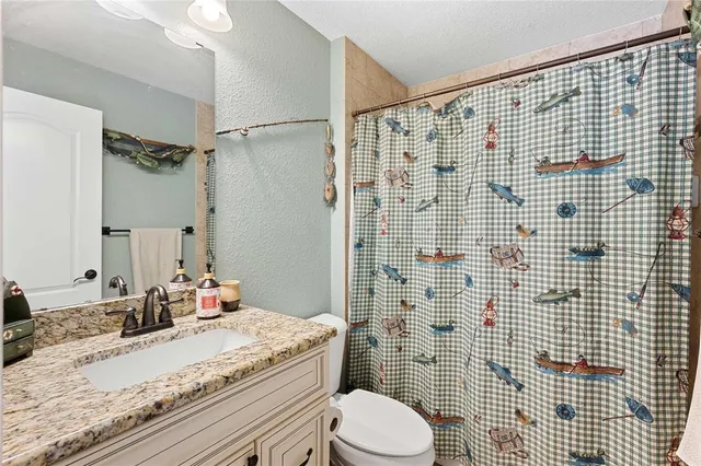 a view of a dining room with furniture large windows and entryway
