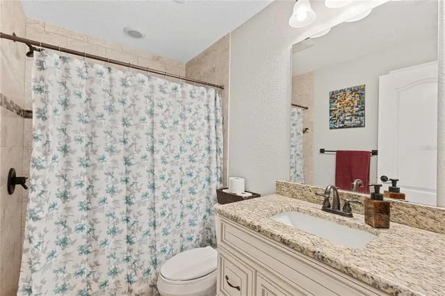 a kitchen with stainless steel appliances granite countertop a sink and a microwave