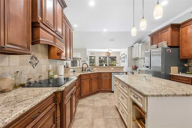 a living room with furniture flat screen tv and a chandelier