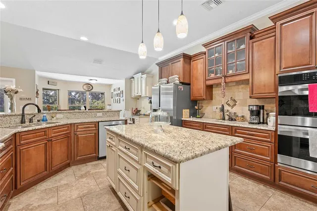 a kitchen with stainless steel appliances granite countertop a stove oven and a sink
