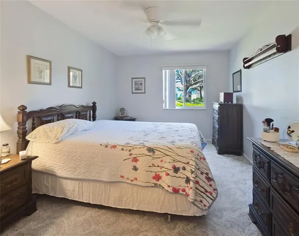 a bedroom with a bed and dresser