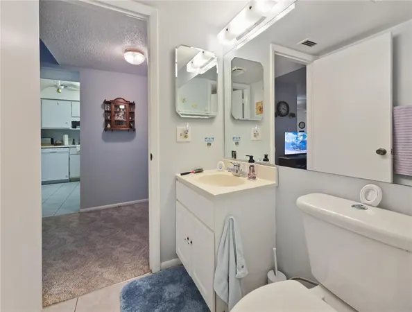 a spacious bathroom with a toilet sink and mirror
