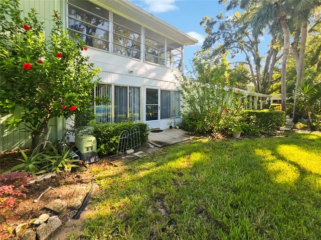 a view of a house with swimming pool and sitting area