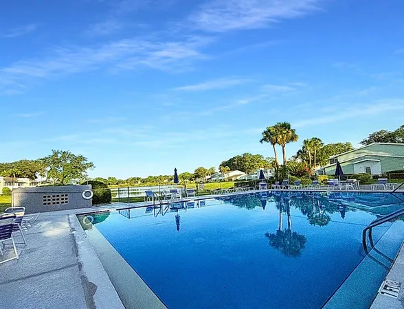 a view of a swimming pool with furniture