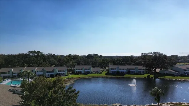 an aerial view of residential house with outdoor space and lake view