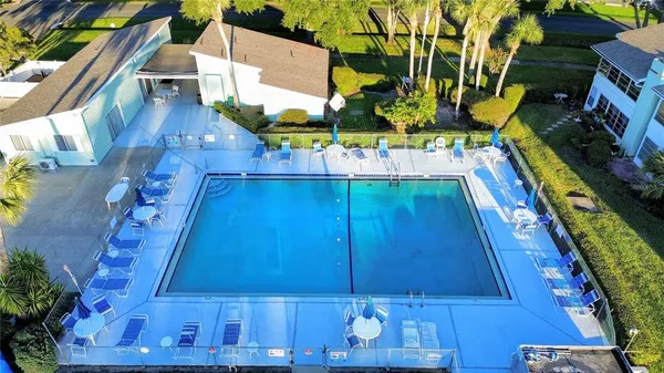 a view of a house with swimming pool and sitting area