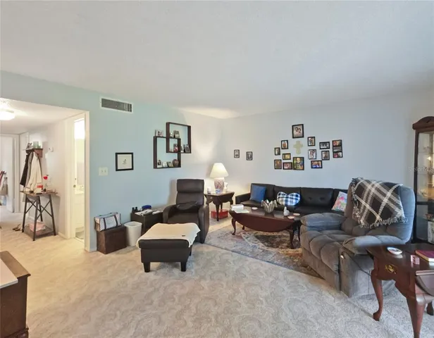 a living room with furniture a lamp and a window