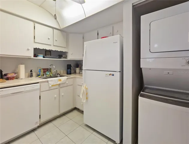 a white refrigerator freezer sitting in a kitchen