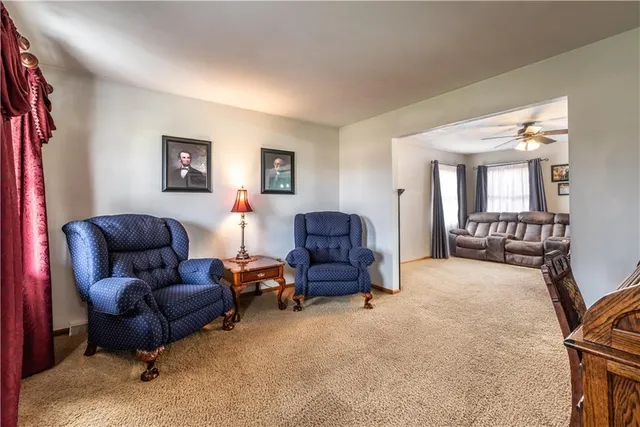 a living room with furniture and a mirror