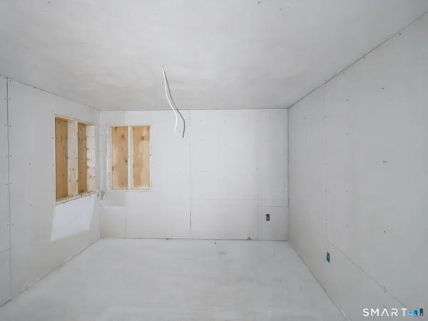a view of a hallway with wooden floor and entryway