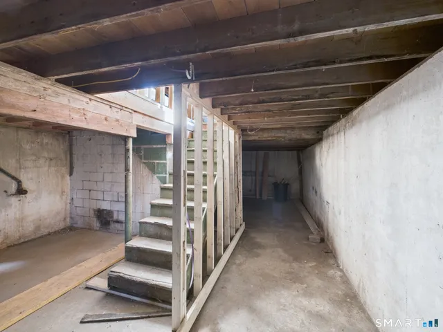 a roof deck with table and chairs