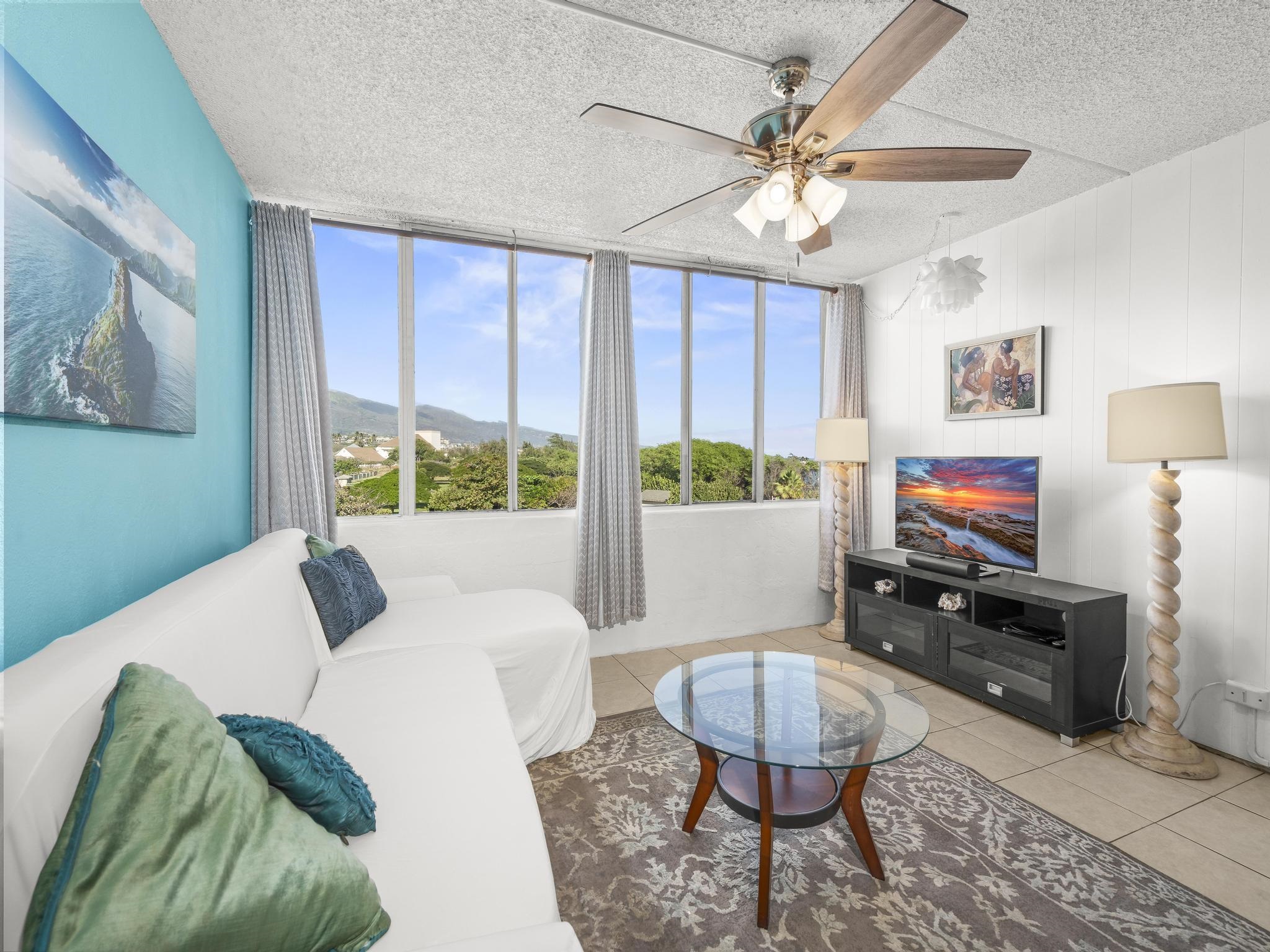 111 Kahului Beach Road, Unit D406 Kahului, HI 96732 - Photo 12 of 30 a living room with furniture and a flat screen tv