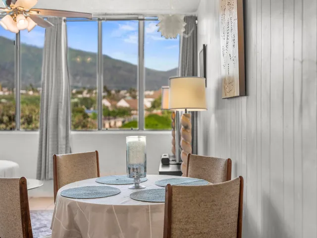 a dining room with furniture and a window