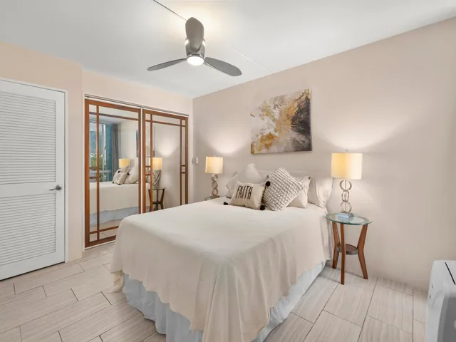 a bedroom with a large bed and a chandelier