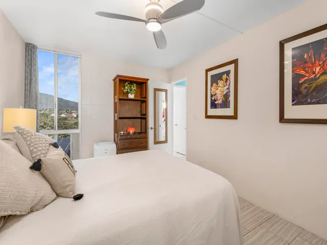 a bedroom with a bed and a large mirror