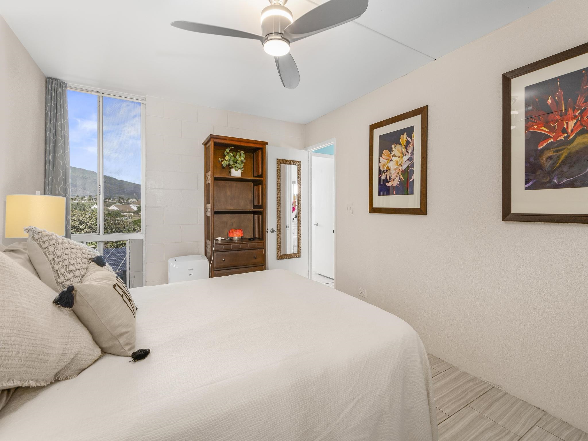 111 Kahului Beach Road, Unit D406 Kahului, HI 96732 - Photo 17 of 30 a bedroom with a bed and a large mirror