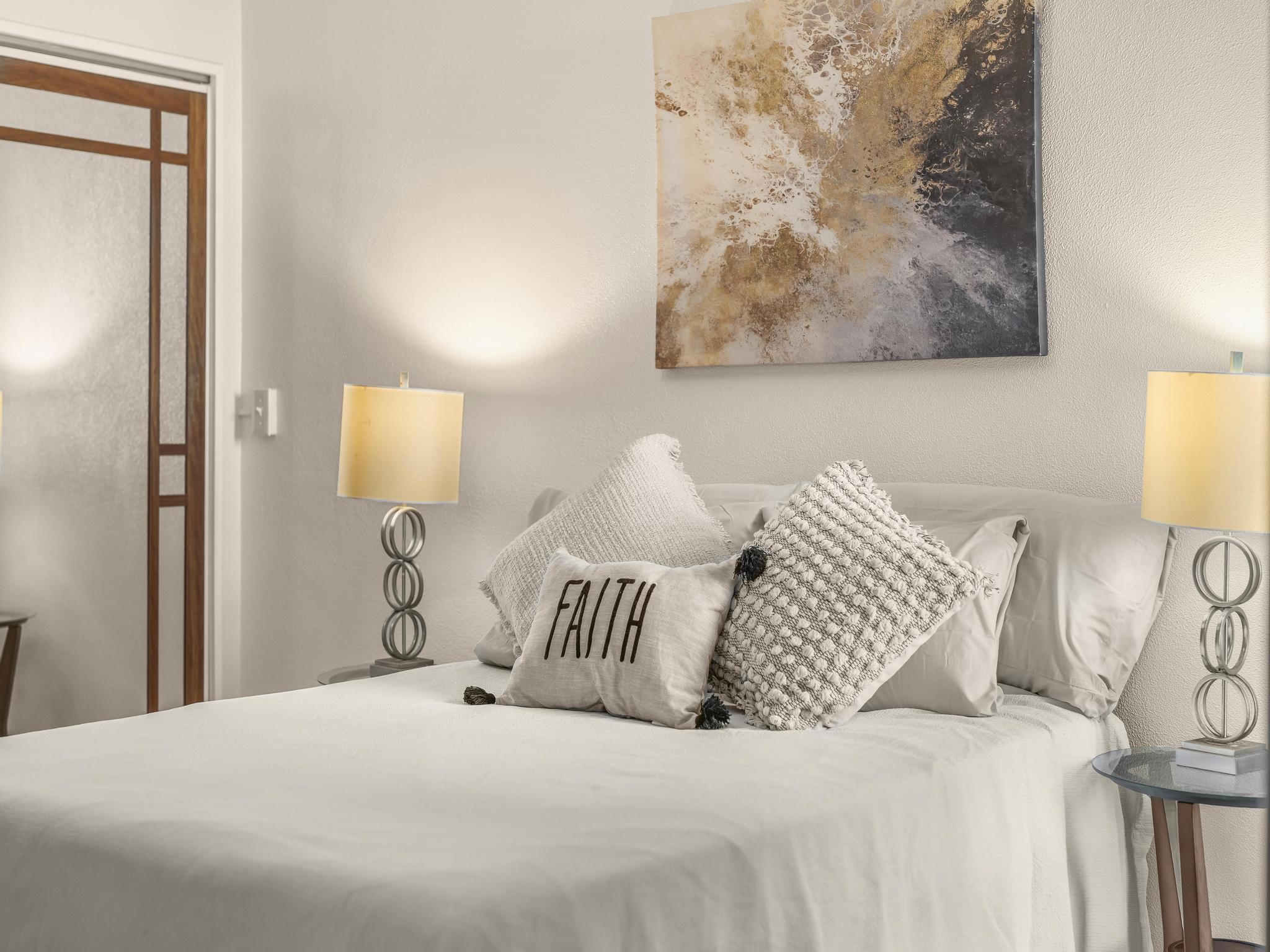 111 Kahului Beach Road, Unit D406 Kahului, HI 96732 - Photo 18 of 30 a bedroom with a bed and a lamp on dresser