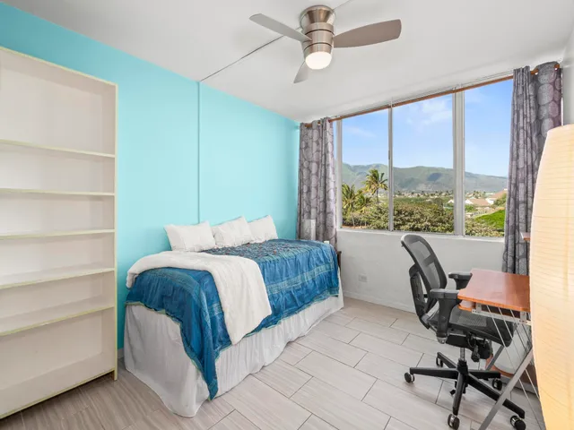 a bedroom with a bed a desk and chair