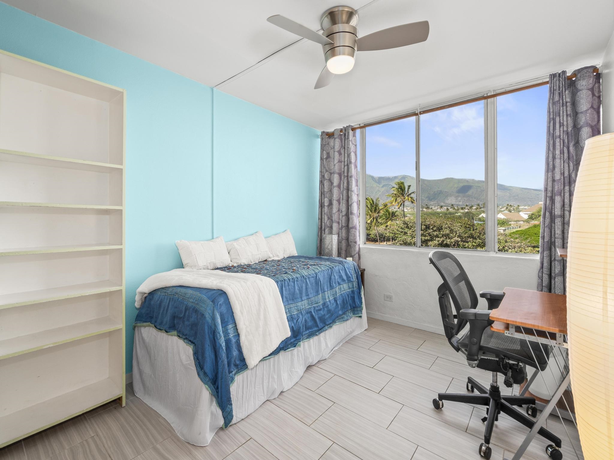 111 Kahului Beach Road, Unit D406 Kahului, HI 96732 - Photo 19 of 30 a bedroom with a bed a desk and chair