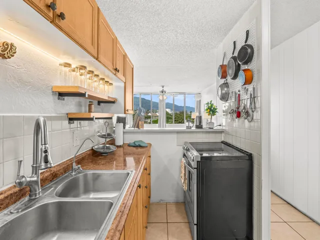 a kitchen with stainless steel appliances granite countertop a sink and a microwave