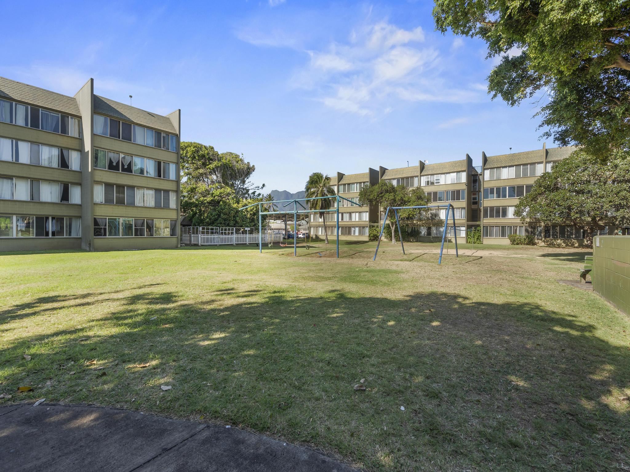 111 Kahului Beach Road, Unit D406 Kahului, HI 96732 - Photo 26 of 30 a view of a building with a big yard and large trees