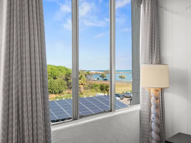 a view of a room that has a bed and a window