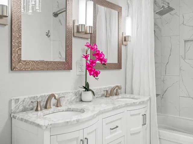a bathroom with a granite countertop sink and a mirror