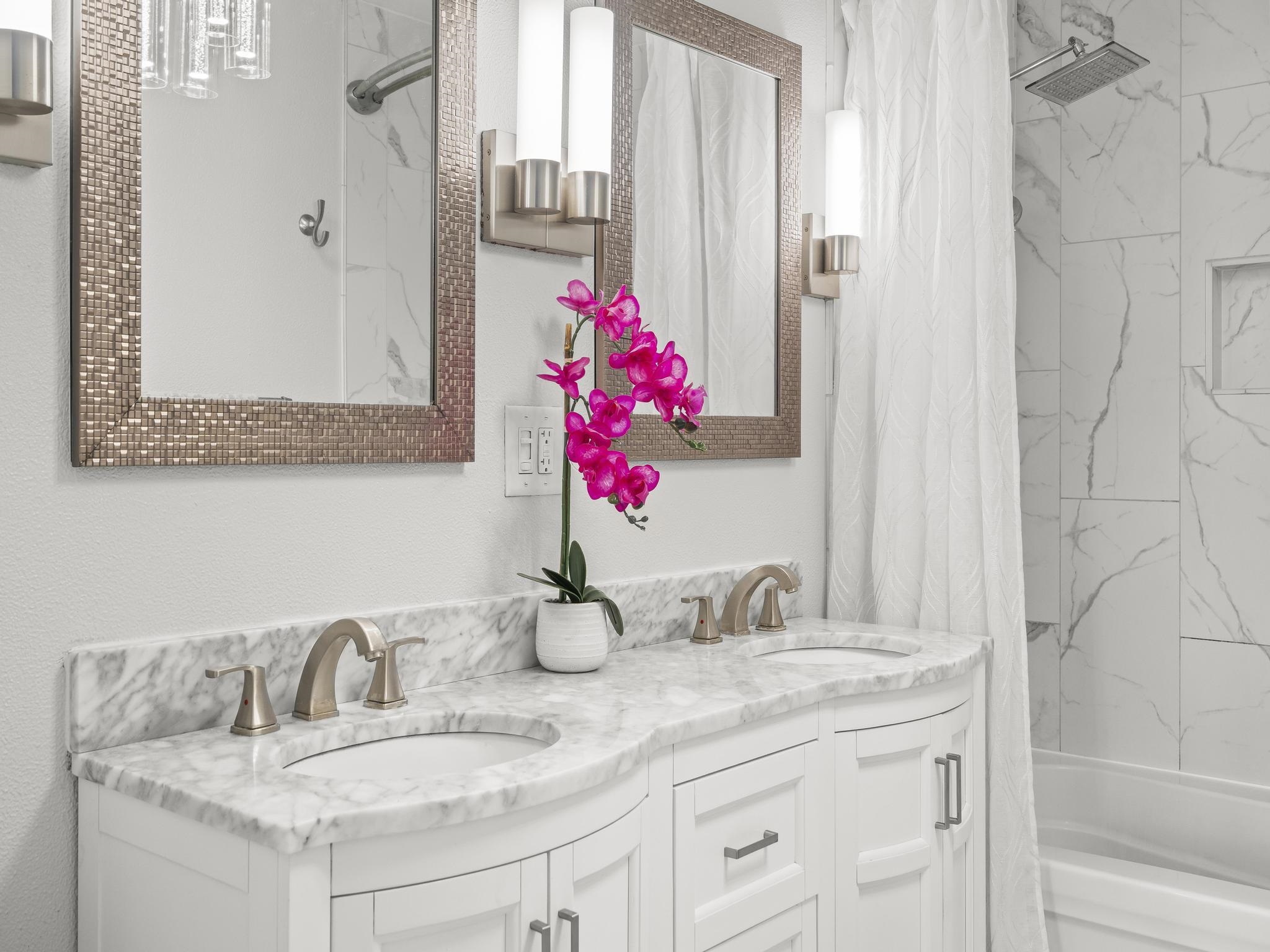 111 Kahului Beach Road, Unit D406 Kahului, HI 96732 - Photo 7 of 30 a bathroom with a granite countertop sink and a mirror