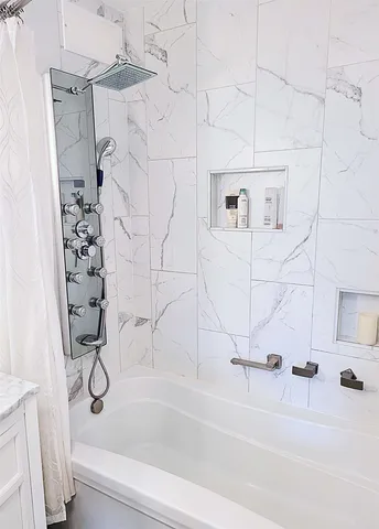 a bathroom with a bathtub and a shower