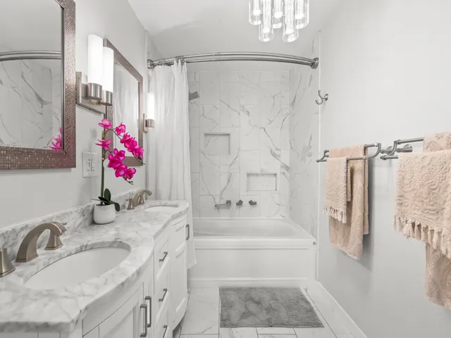 a bathroom with a granite countertop shower sink vanity granite and shower