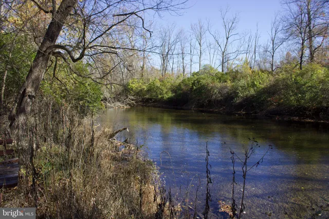a view of a lake with a house in background