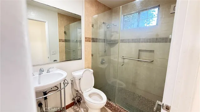 a bathroom with a sink toilet and shower