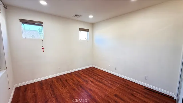 a view of room with wooden floor and fan