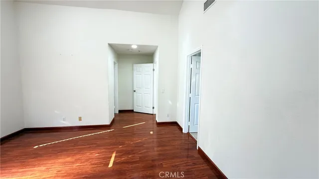 a view of a room with wooden floor and white wall