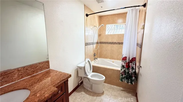 a bath room with a toilet and a bath tub
