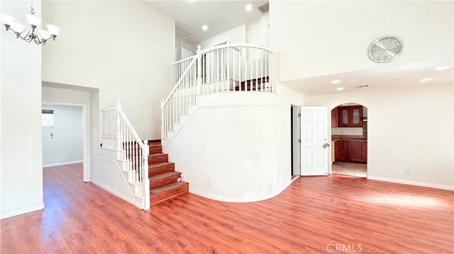 a view of a hallway with wooden floor and staircase