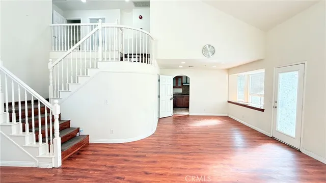 a view of a hallway with wooden floor and entryway