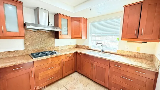 a kitchen with granite countertop cabinets sink and window