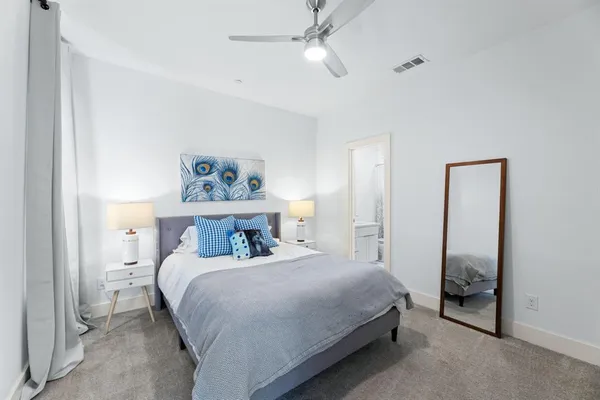 a living room with furniture a rug and a flat screen tv