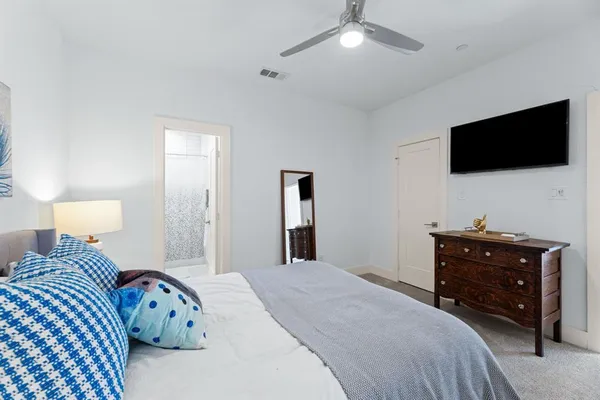 a bedroom with a bed and a chandelier