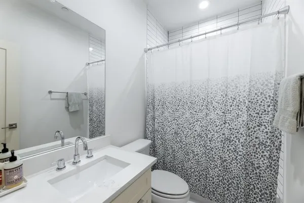 a bed room with a bed and a painting on the wall