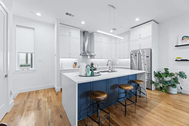 a kitchen that has a sink and a stove in it