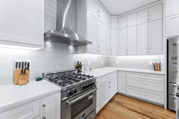 a kitchen with a sink stainless steel appliances and cabinets